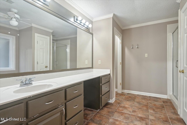 2674 S Slayden Rd, Lamar, MS 38642 - bathroom featuring a textured ceiling, vanity, ceiling fan, crown molding, and a shower with shower door