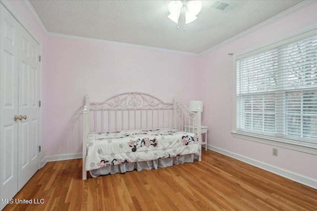 2674 S Slayden Rd, Lamar, MS 38642 - bedroom with hardwood / wood-style flooring, a closet, and ornamental molding