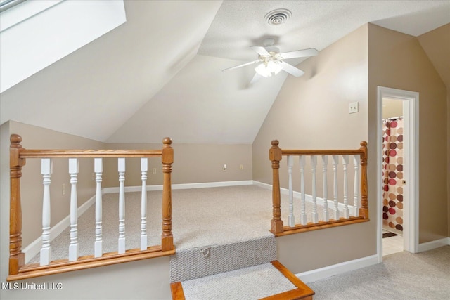 2674 S Slayden Rd, Lamar, MS 38642 - stairway with ceiling fan, carpet floors, and lofted ceiling with skylight