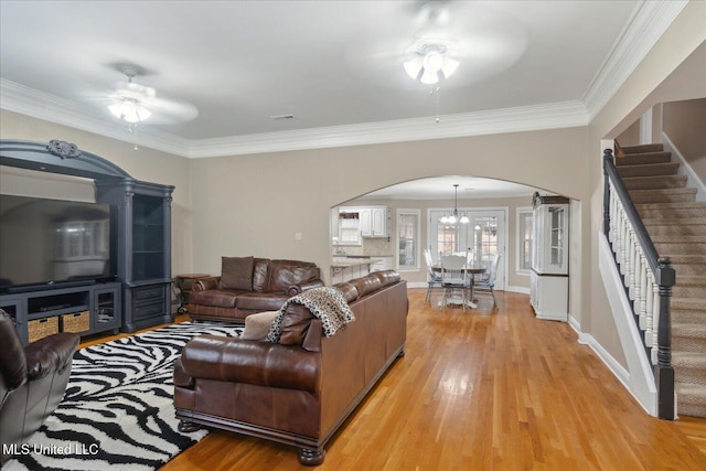2674 S Slayden Rd, Lamar, MS 38642 - living room with ceiling fan with notable chandelier, light hardwood / wood-style flooring, and crown molding