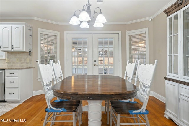 2674 S Slayden Rd, Lamar, MS 38642 - dining area featuring crown molding, light hardwood / wood-style flooring, french doors, and a notable chandelier