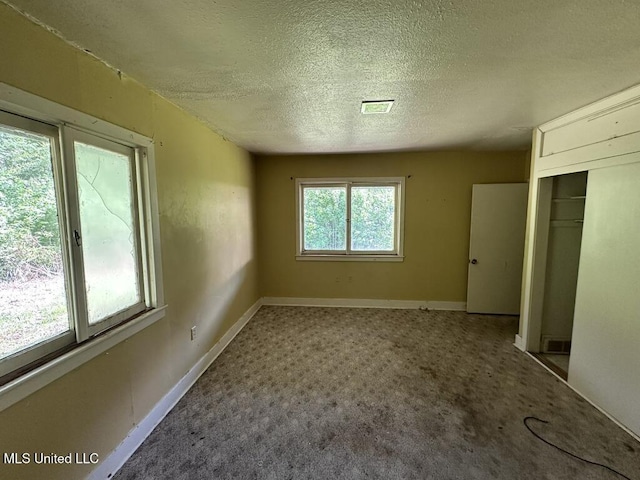 417 Boulevard St, Lexington, MS 39095 - unfurnished bedroom featuring a textured ceiling, carpet flooring, a closet, and baseboards
