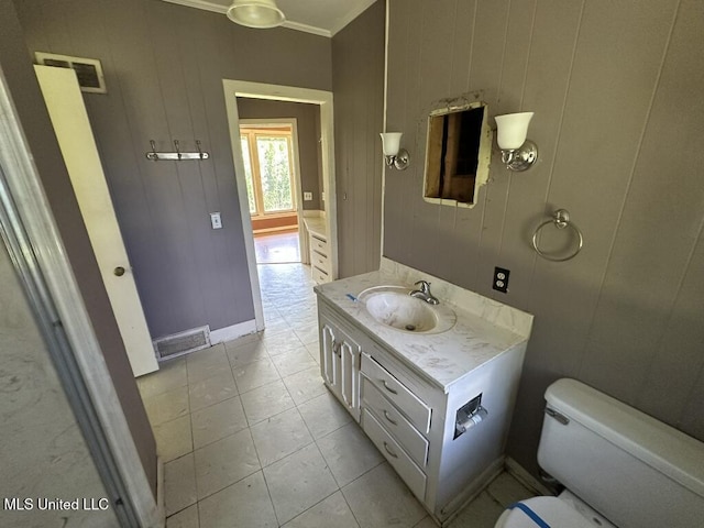 417 Boulevard St, Lexington, MS 39095 - half bath featuring vanity, toilet, crown molding, and tile patterned flooring