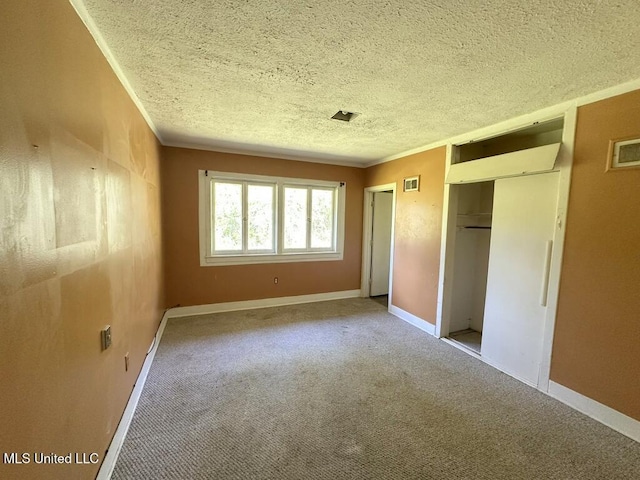 417 Boulevard St, Lexington, MS 39095 - unfurnished bedroom with two closets, a textured ceiling, carpet flooring, ornamental molding, and baseboards