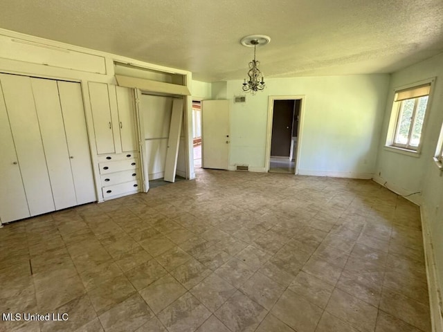 417 Boulevard St, Lexington, MS 39095 - unfurnished bedroom with a textured ceiling and a chandelier