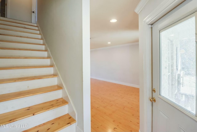 stairway featuring recessed lighting, crown molding, and baseboards