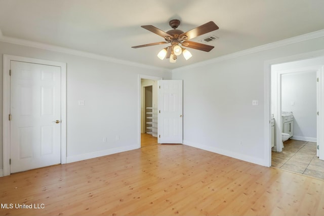 unfurnished bedroom with ornamental molding, visible vents, light wood-style floors, and baseboards