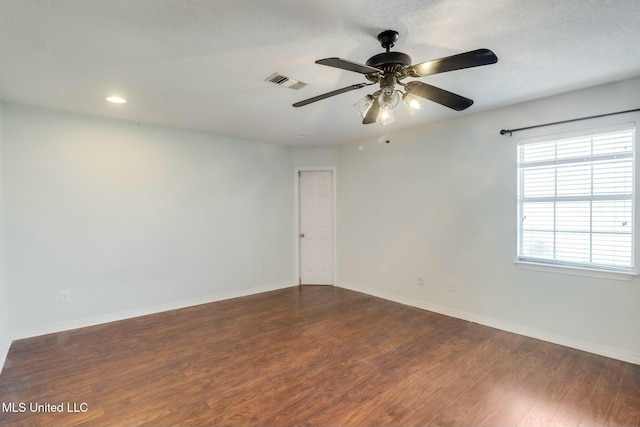 empty room with ceiling fan, recessed lighting, wood finished floors, visible vents, and baseboards