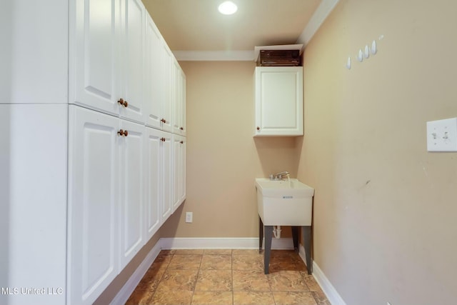 laundry area with baseboards