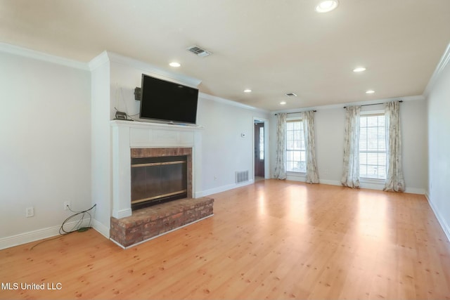 unfurnished living room featuring a brick fireplace, visible vents, and light wood-style floors