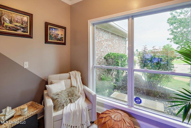 sitting room with plenty of natural light and crown molding
