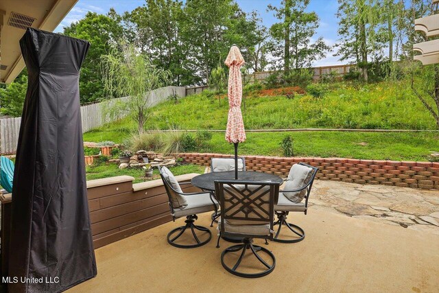 view of patio / terrace with outdoor dining space and fence