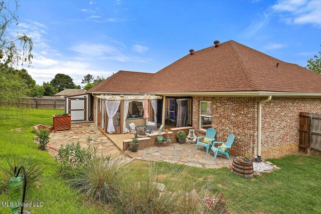 back of house with a patio, brick siding, and roof with shingles