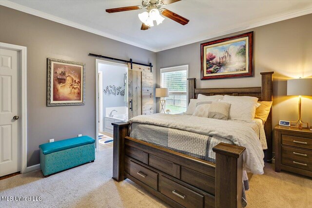 bedroom with light carpet, ornamental molding, a barn door, baseboards, and a ceiling fan