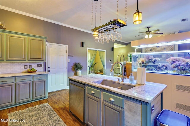 kitchen with a sink, dishwasher, ornamental molding, an island with sink, and ceiling fan