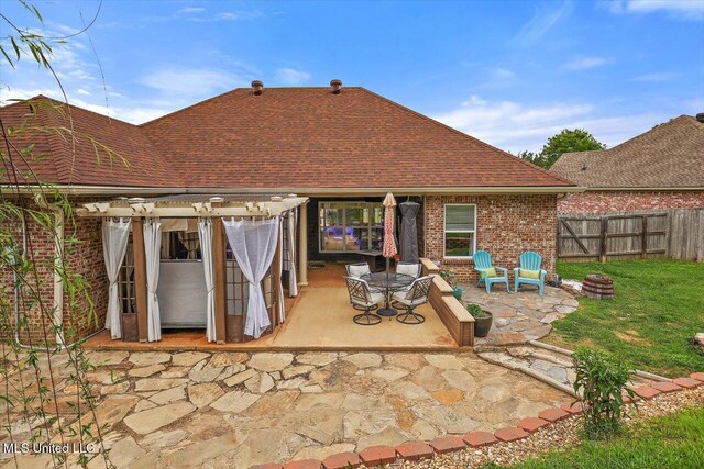 rear view of property with a patio area, a shingled roof, a pergola, and brick siding