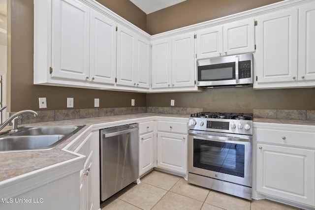 1013 Brashears Pt, Ridgeland, MS 39157 - kitchen with stainless steel appliances, light tile patterned floors, and white cabinets