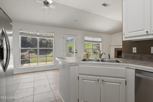 1013 Brashears Pt, Ridgeland, MS 39157 - kitchen featuring stainless steel appliances, a peninsula, white cabinetry, a ceiling fan, and light tile patterned floors