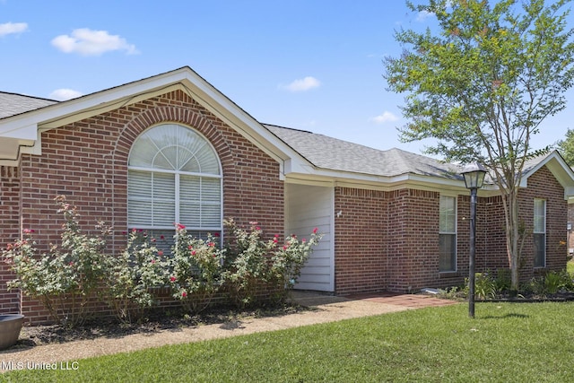 1013 Brashears Pt, Ridgeland, MS 39157 - view of front of home featuring brick siding, a front yard, and a shingled roof