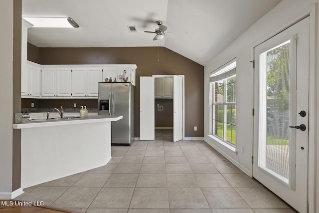 1013 Brashears Pt, Ridgeland, MS 39157 - kitchen featuring stainless steel fridge, a ceiling fan, lofted ceiling, white cabinetry, and light tile patterned flooring