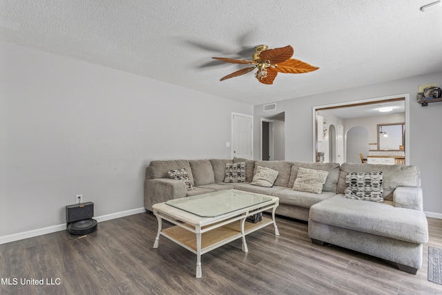 10510 Steeplechase Dr, Gulfport, MS 39503 - living room featuring ceiling fan, arched walkways, wood finished floors, and a textured ceiling