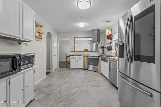 10510 Steeplechase Dr, Gulfport, MS 39503 - kitchen featuring appliances with stainless steel finishes, extractor fan, arched walkways, a textured ceiling, and white cabinets