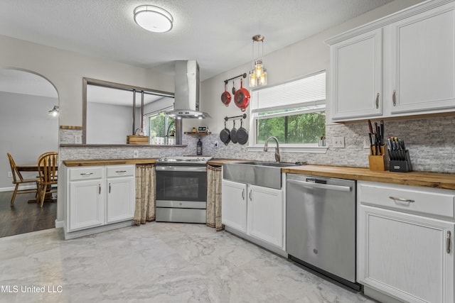 10510 Steeplechase Dr, Gulfport, MS 39503 - kitchen with stainless steel appliances, island range hood, butcher block countertops, tasteful backsplash, and white cabinets