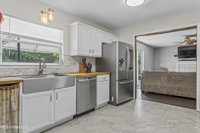 10510 Steeplechase Dr, Gulfport, MS 39503 - kitchen with stainless steel appliances, tasteful backsplash, open floor plan, white cabinetry, and plenty of natural light