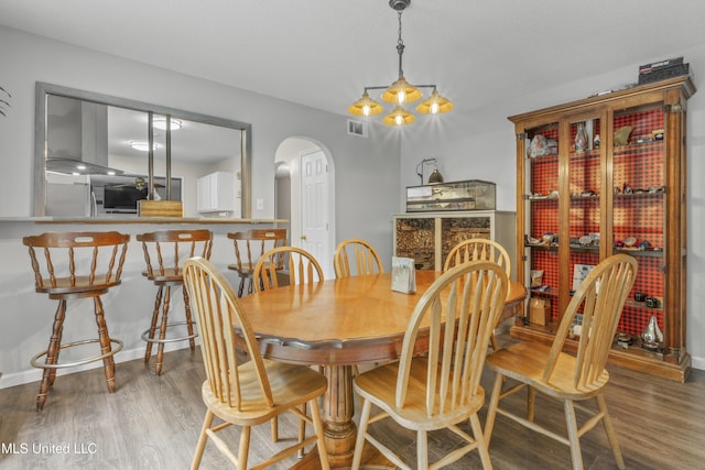 10510 Steeplechase Dr, Gulfport, MS 39503 - dining area with arched walkways and wood finished floors
