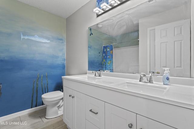 10510 Steeplechase Dr, Gulfport, MS 39503 - bathroom featuring double vanity, a shower with curtain, and wood finished floors