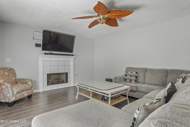 10510 Steeplechase Dr, Gulfport, MS 39503 - living room featuring ceiling fan, a textured ceiling, wood finished floors, and a fireplace