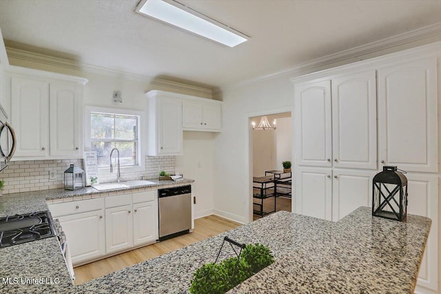 kitchen with stainless steel dishwasher, white cabinetry, and sink