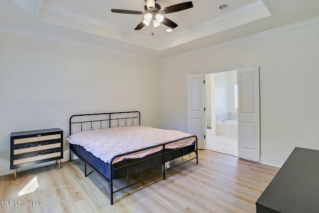 bedroom featuring ceiling fan, light hardwood / wood-style flooring, crown molding, and a tray ceiling