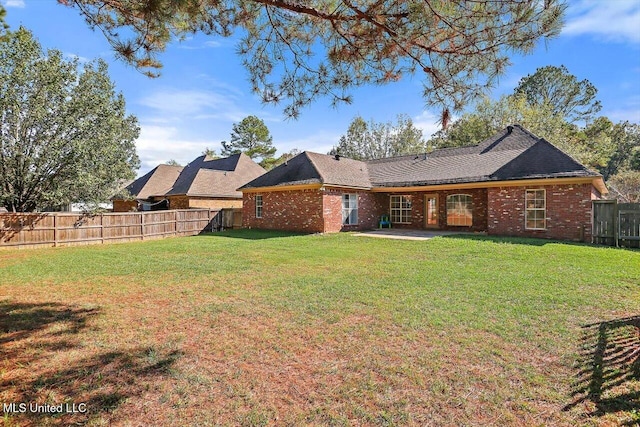 rear view of house with a lawn