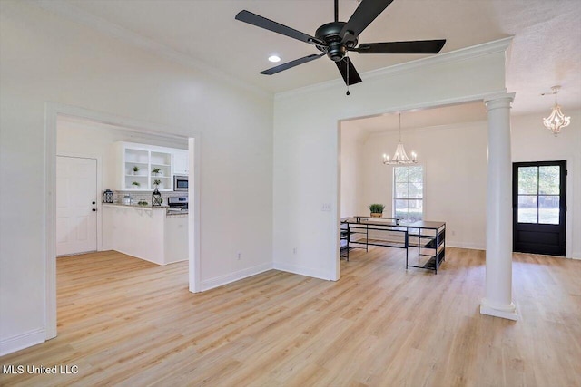 interior space featuring ornamental molding, light wood-type flooring, ornate columns, and ceiling fan with notable chandelier