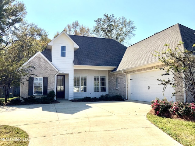 182 Sweetbriar Cir, Canton, MS 39046 - view of front of home with concrete driveway, a shingled roof, an attached garage, and brick siding