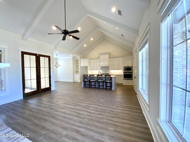 182 Sweetbriar Cir, Canton, MS 39046 - unfurnished living room with high vaulted ceiling, dark wood-type flooring, a ceiling fan, french doors, and baseboards