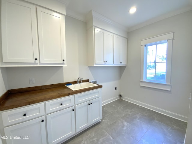 182 Sweetbriar Cir, Canton, MS 39046 - washroom with electric dryer hookup, cabinet space, hookup for a washing machine, baseboards, and ornamental molding