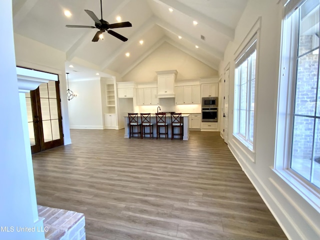 182 Sweetbriar Cir, Canton, MS 39046 - living room with high vaulted ceiling, baseboards, dark wood-style floors, a ceiling fan, and beamed ceiling