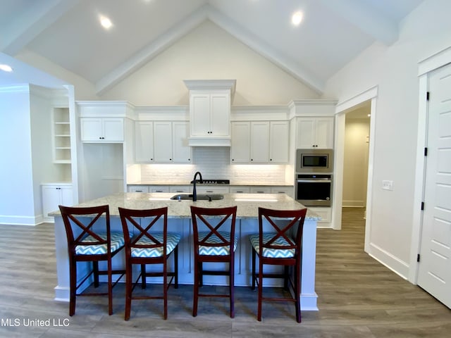 182 Sweetbriar Cir, Canton, MS 39046 - kitchen featuring stainless steel appliances, a sink, white cabinetry, a center island with sink, and dark wood-type flooring