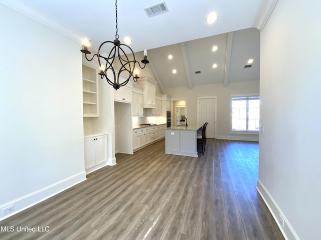 182 Sweetbriar Cir, Canton, MS 39046 - kitchen with a chandelier, a sink, a center island with sink, dark wood finished floors, and white cabinets