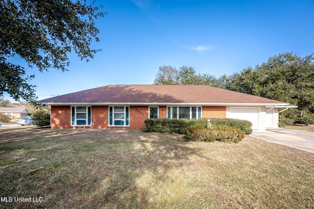 ranch-style home featuring a garage and a front lawn