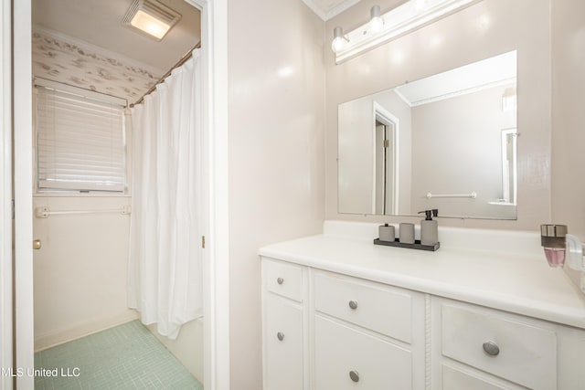 bathroom featuring tile patterned flooring, vanity, and ornamental molding