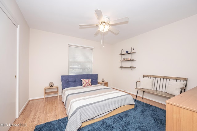 bedroom with a closet, light hardwood / wood-style flooring, and ceiling fan