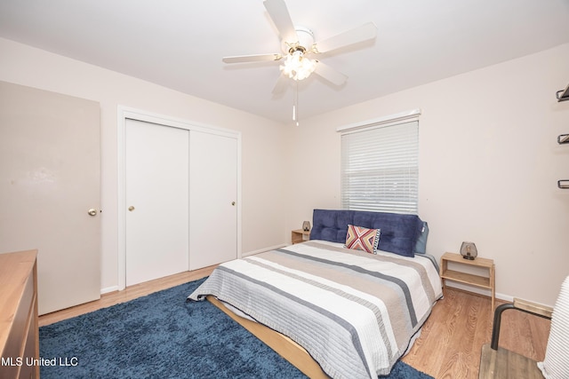 bedroom with a closet, ceiling fan, and light hardwood / wood-style floors