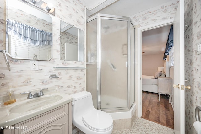 bathroom featuring hardwood / wood-style floors, vanity, toilet, and a shower with door