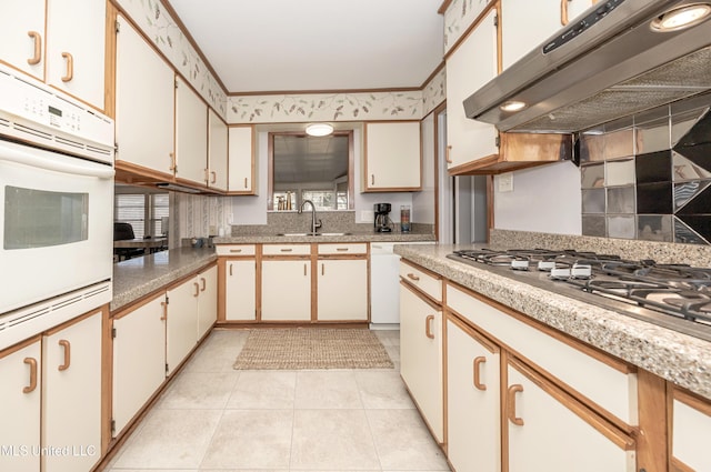 kitchen with white cabinets, white appliances, extractor fan, and sink