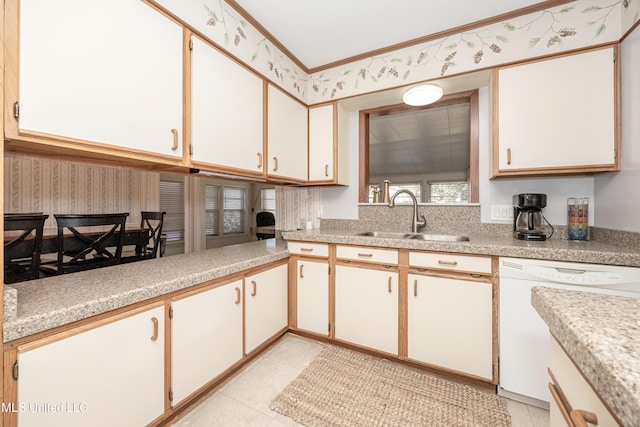 kitchen featuring dishwasher, light tile patterned floors, white cabinets, and sink