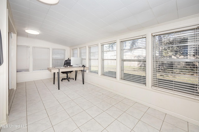 tiled home office featuring vaulted ceiling