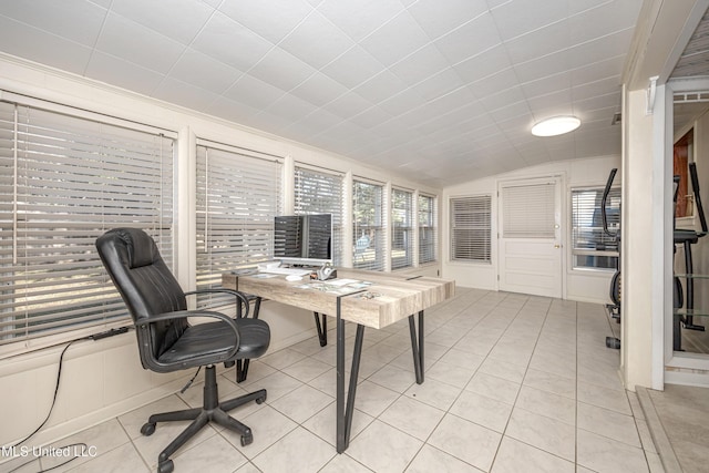 office space with light tile patterned floors, vaulted ceiling, and crown molding